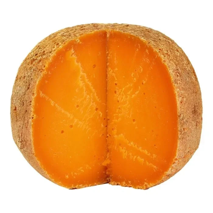 Artisan orange cheese wheel with rich, creamy texture, perfect for gourmet French pantry collections.