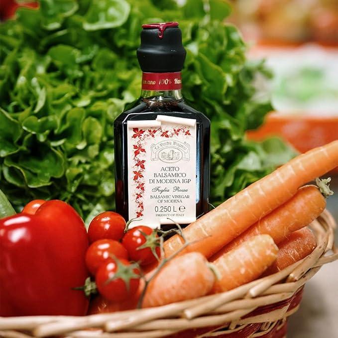 Balsamic vinegar of Modena IGP with fresh vegetables in a basket