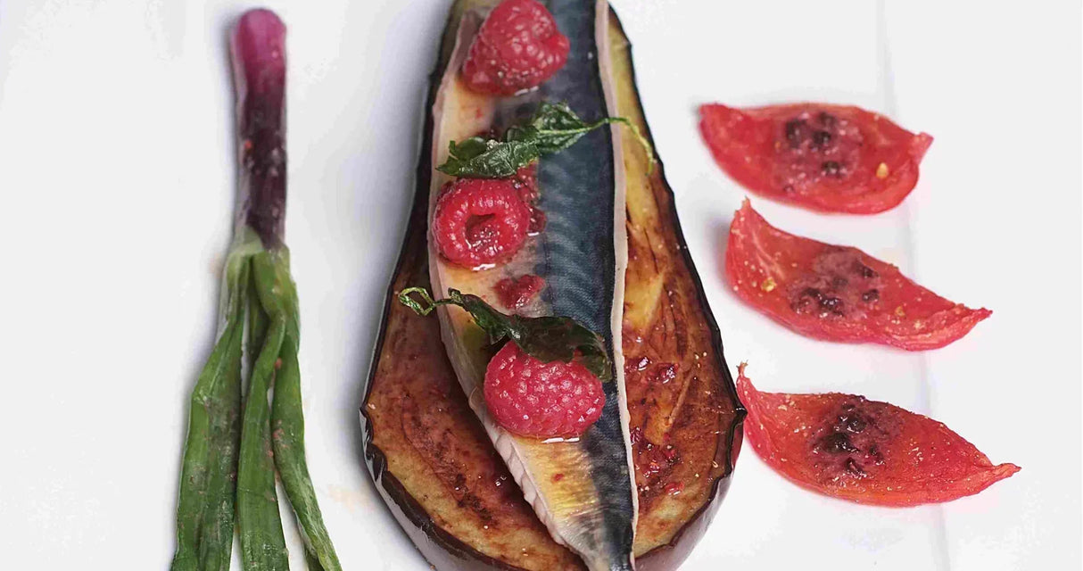 Grilled eggplant with raspberries, basil, and roasted tomatoes, artisan gourmet dish