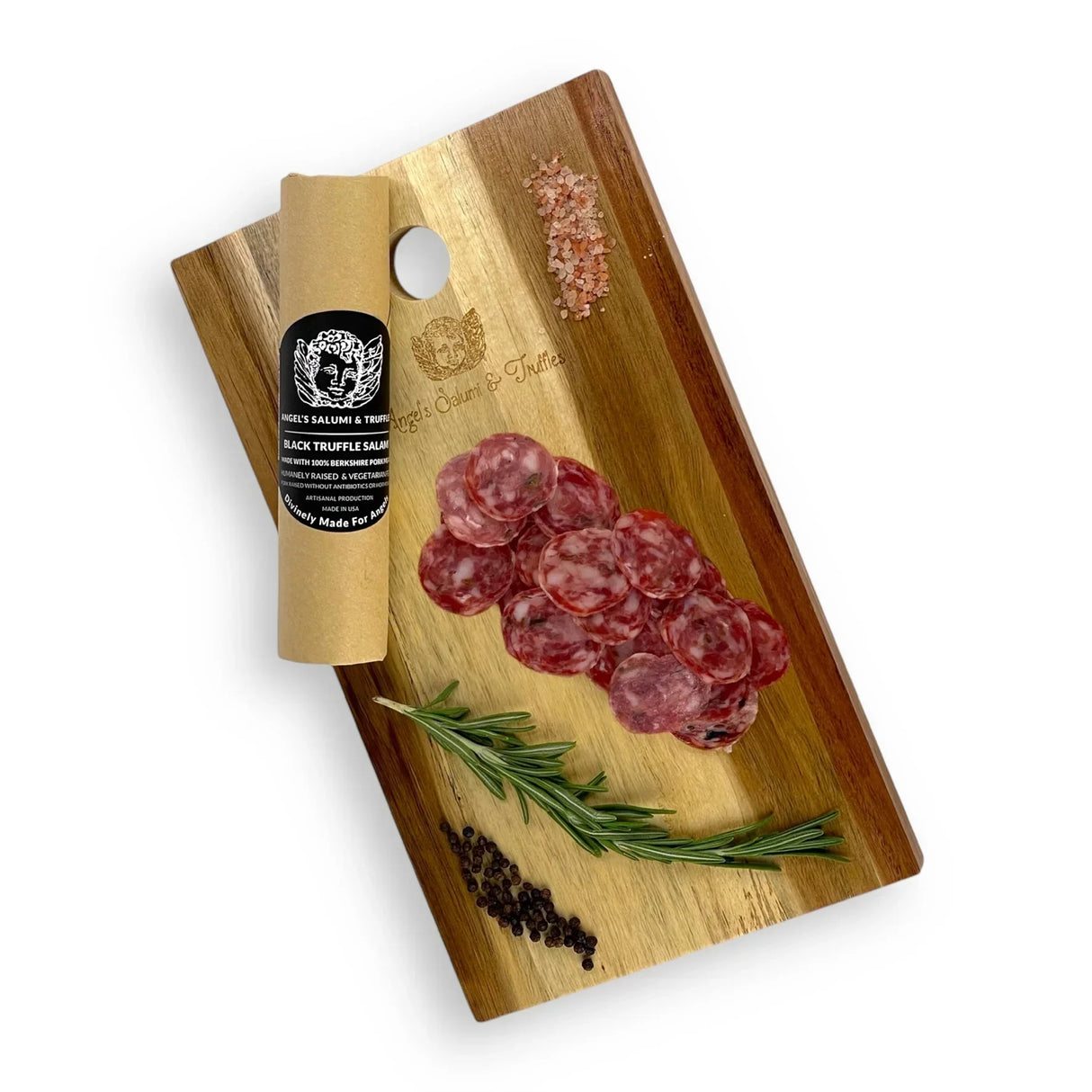 Black truffle salami slices on wooden board with rosemary, pink salt, and peppercorns, artisanal charcuterie
