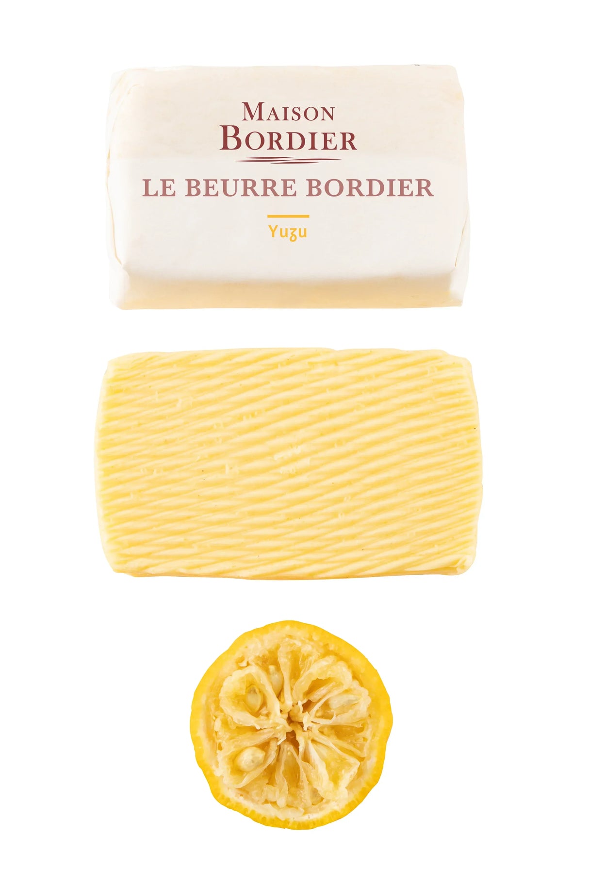 Maison Bordier Yuzu butter with textured surface and citrus slice, premium French artisan butter