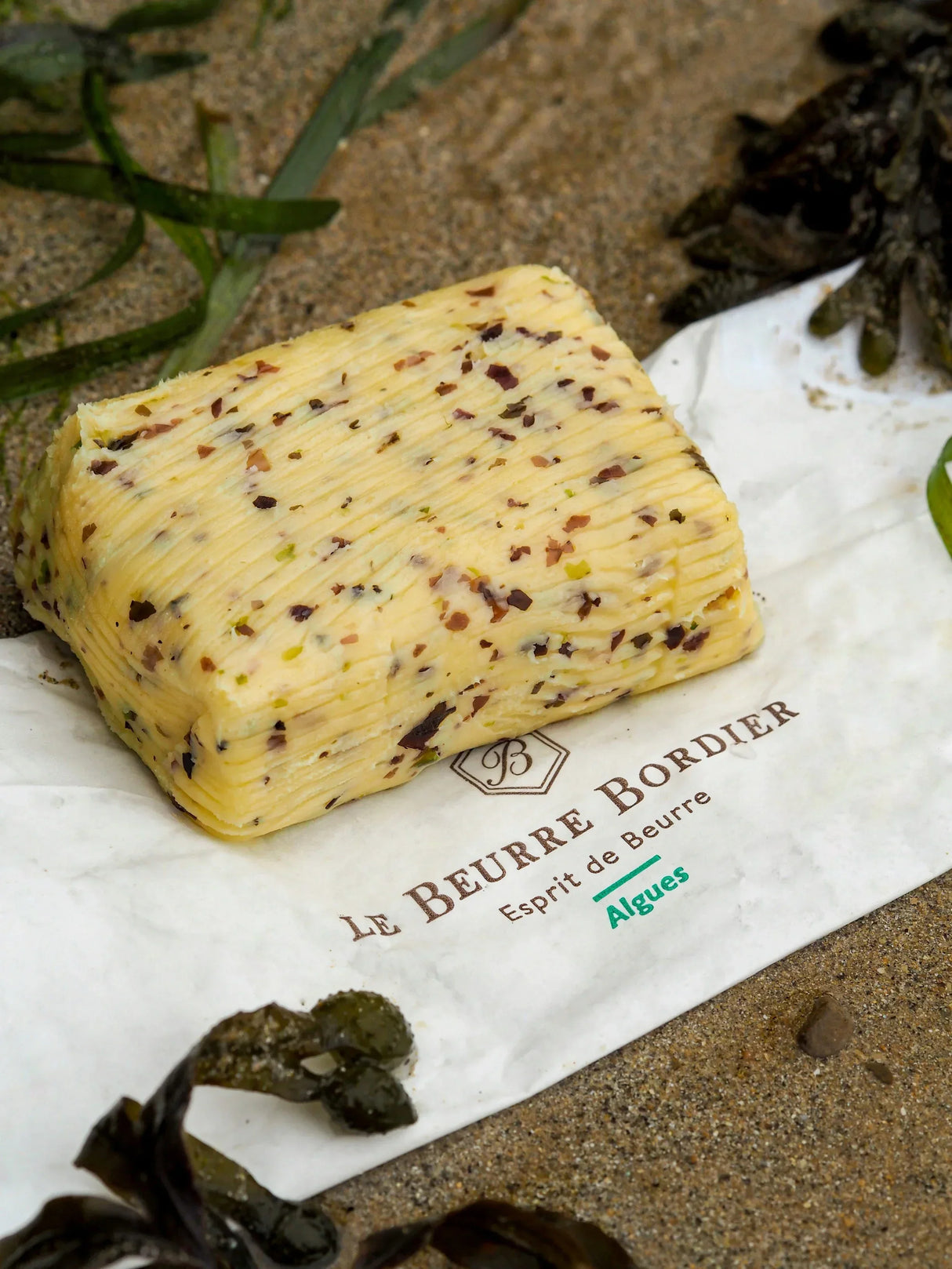 Artisan French butter with seaweed, premium quality, all-natural, grass-fed, on sandy beach