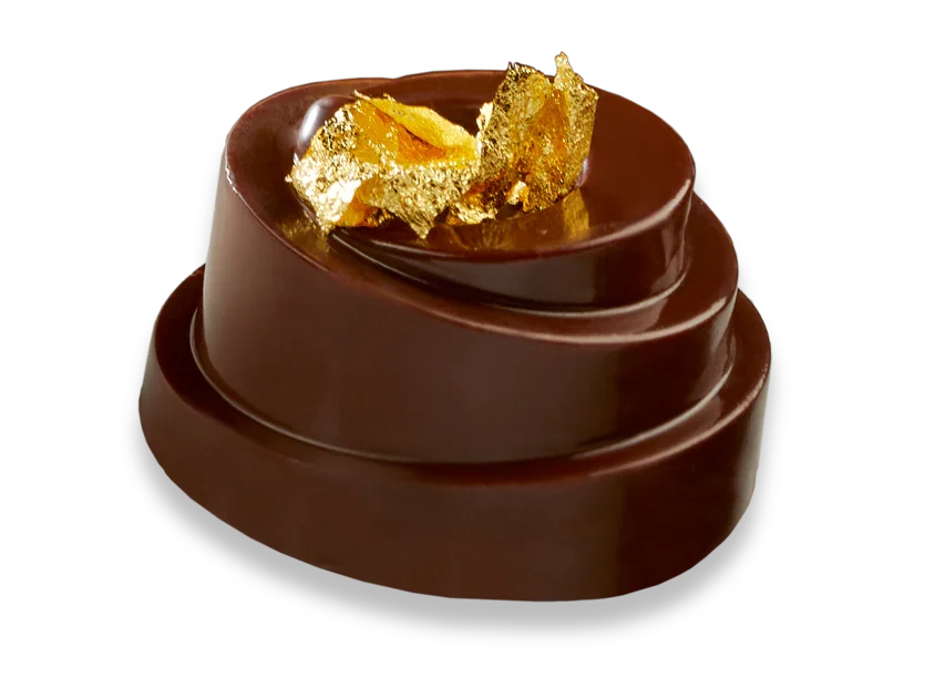 Elegant gourmet chocolate dessert topped with edible gold leaf, premium French confection