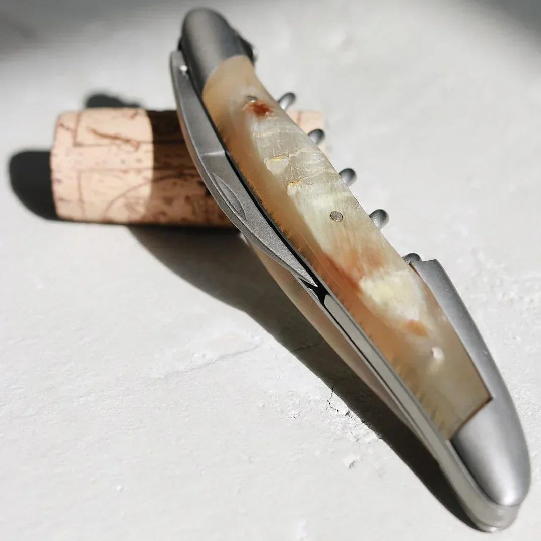 Elegant bone-handled wine opener with cork, artisan tool for premium French wine service