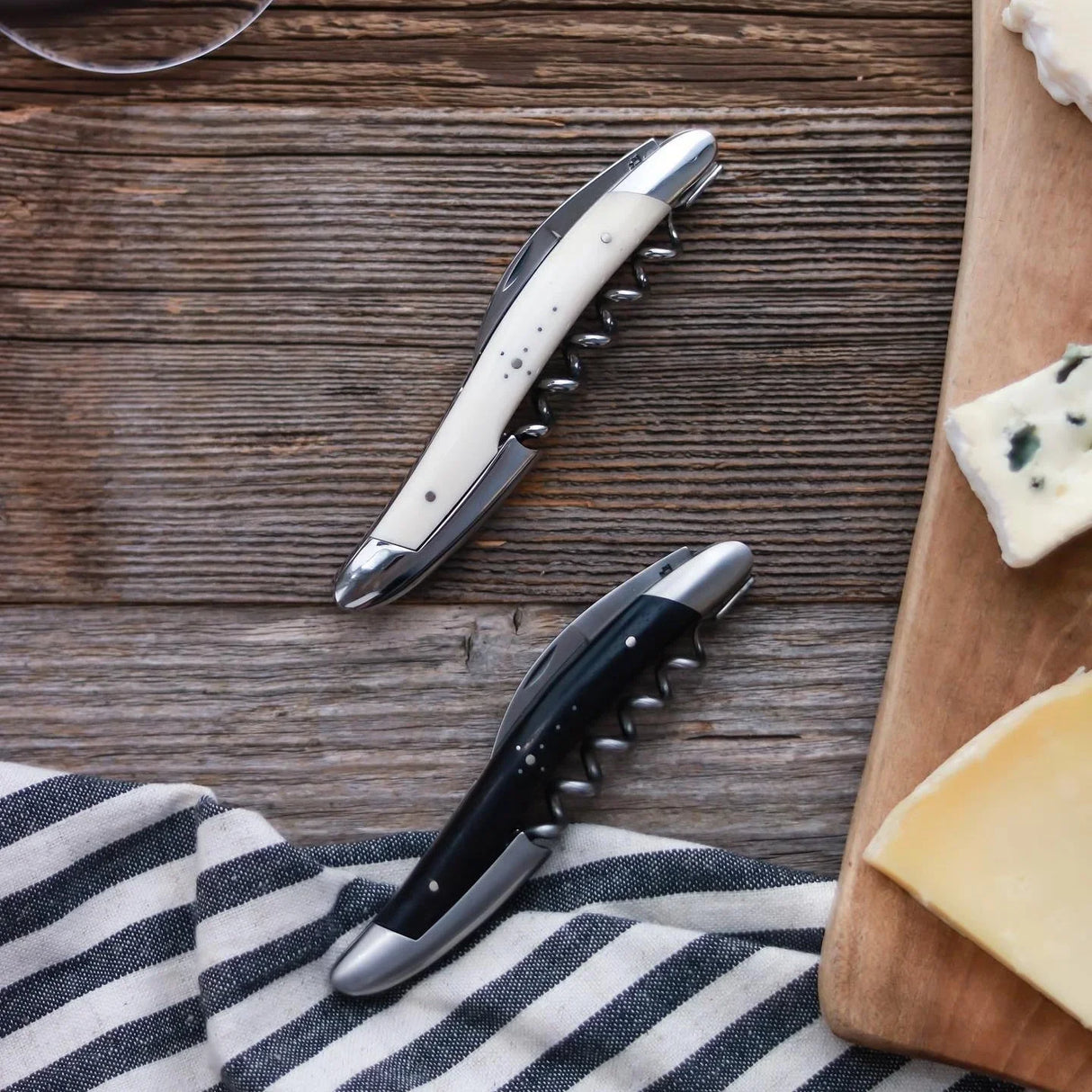 Forge de Laguiole bone handle corkscrews on rustic wood with French cheese, The French Pantry