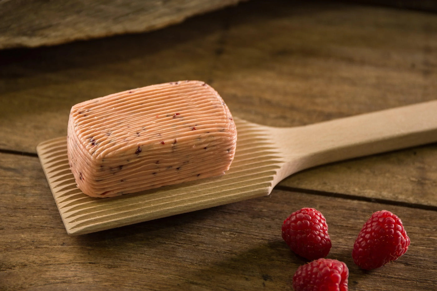 Raspberry butter on wooden paddle with fresh berries, artisan-made, all-natural, premium French spread