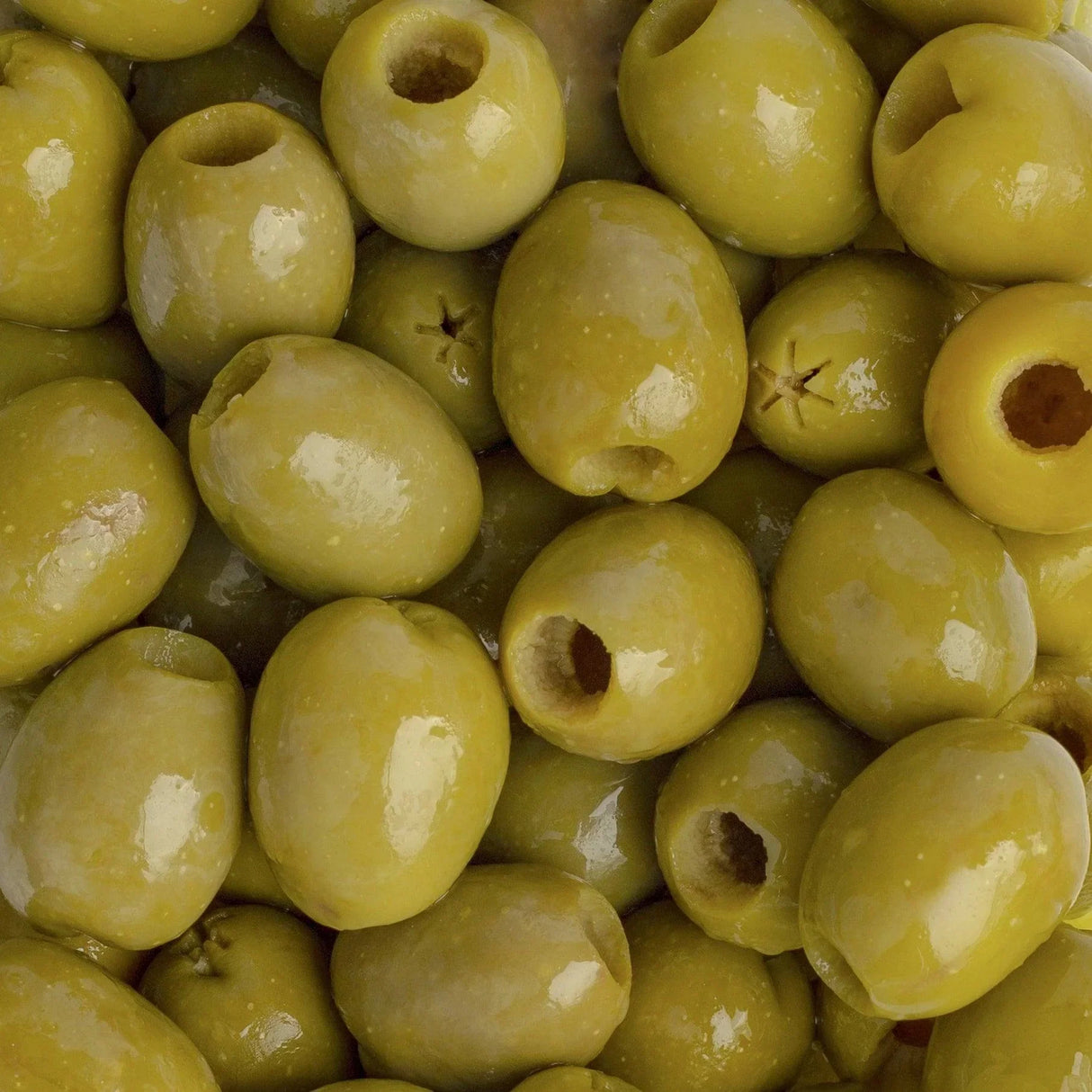 Premium green olives, pitted and glossy, perfect for gourmet French pantry essentials.