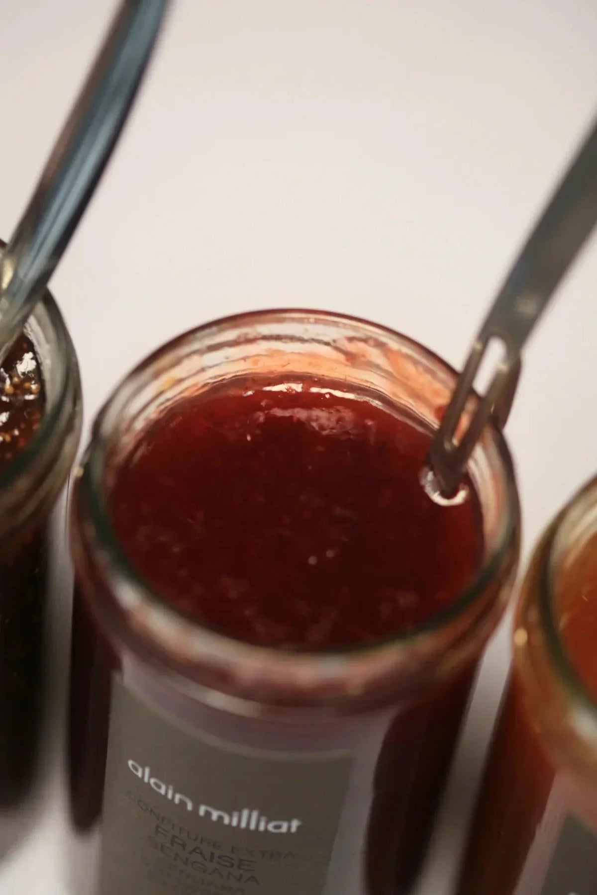 Alain Milliat strawberry ginger jam in glass jar, artisan French preserve with spoon, premium quality
