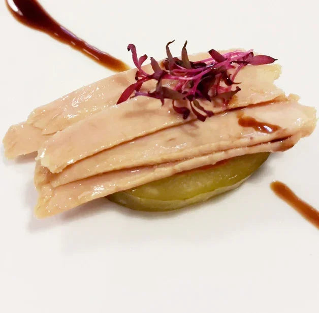 Ventresca tuna fillets over potato with microgreens and balsamic, plated Spanish conserva