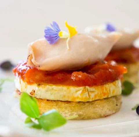 Gourmet French appetizer with squid, zucchini, tomato sauce, edible flowers, French Pantry
