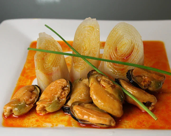 Mussels in rich sauce with leeks and chives, artisan Spanish seafood dish