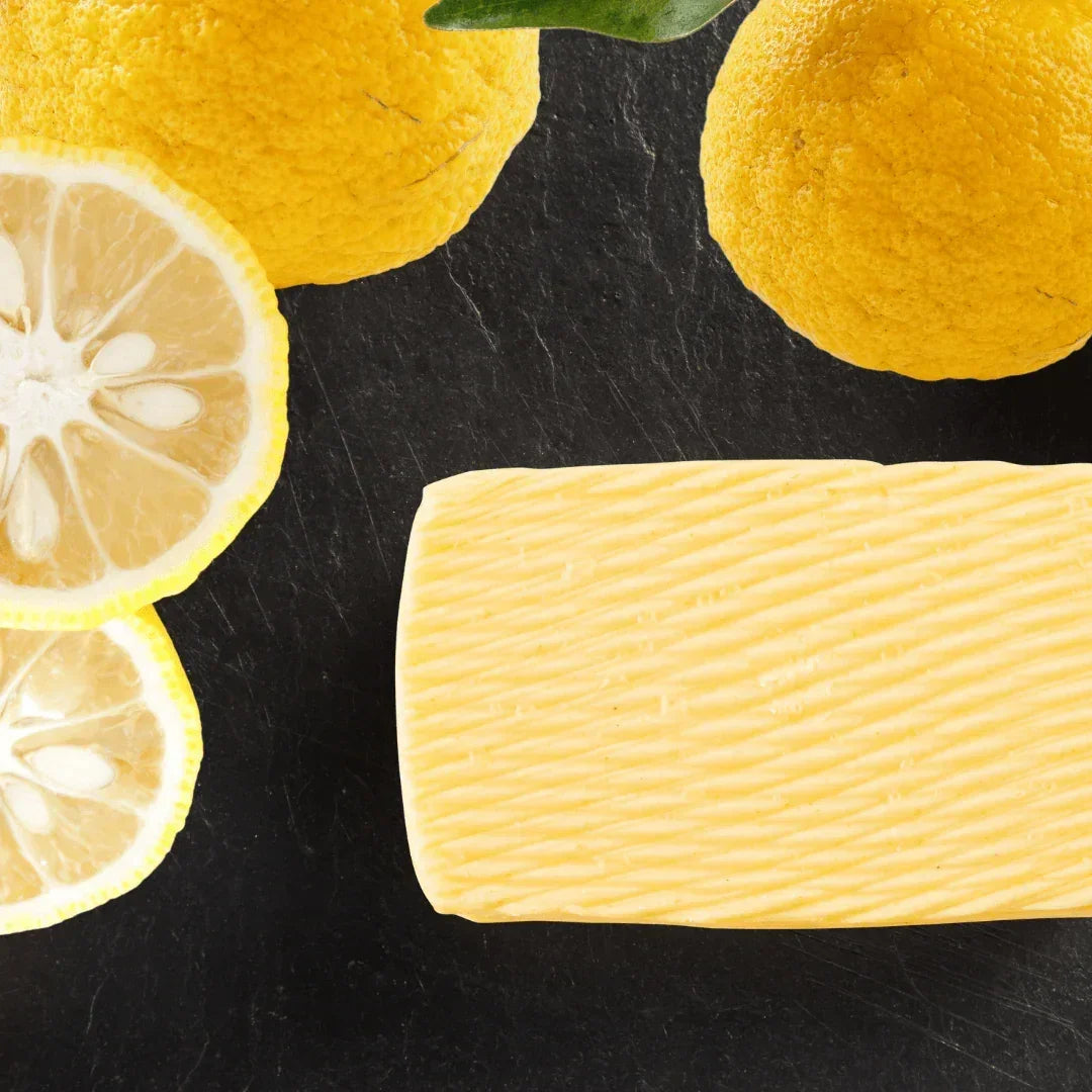 Artisan French butter with fresh lemons on dark slate, premium all-natural dairy