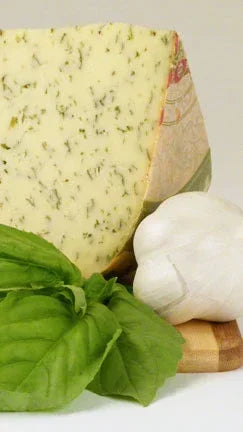 Herb-infused artisan cheese wedge with fresh basil and garlic, premium French pantry staple