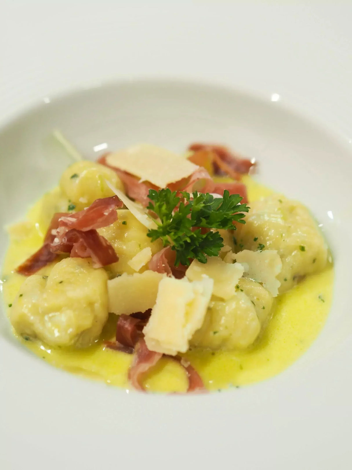 Creamy gnocchi with prosciutto, Parmesan, and parsley in a rich butter sauce
