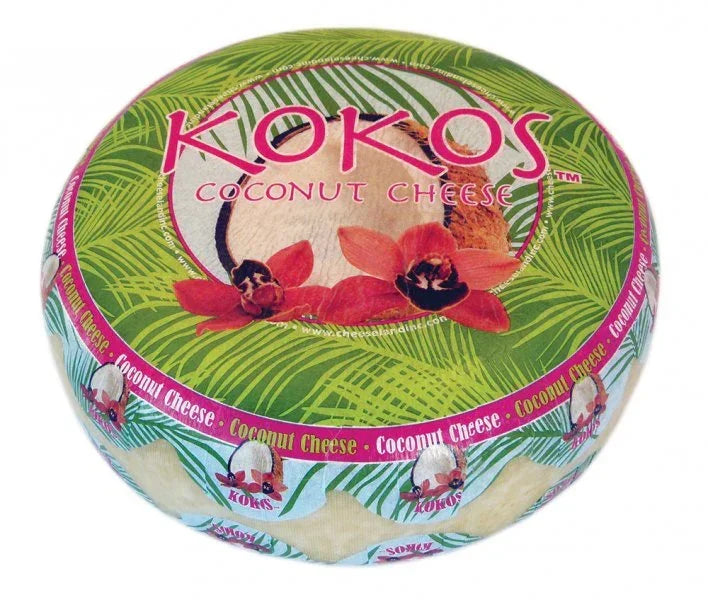 Kokos Coconut Cheese wheel with tropical leaf and orchid design, artisanal dairy-free cheese alternative