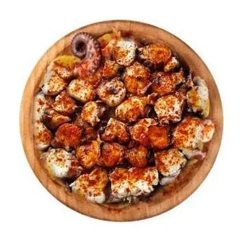 Grilled octopus seasoned with smoked paprika served on a wooden platter.