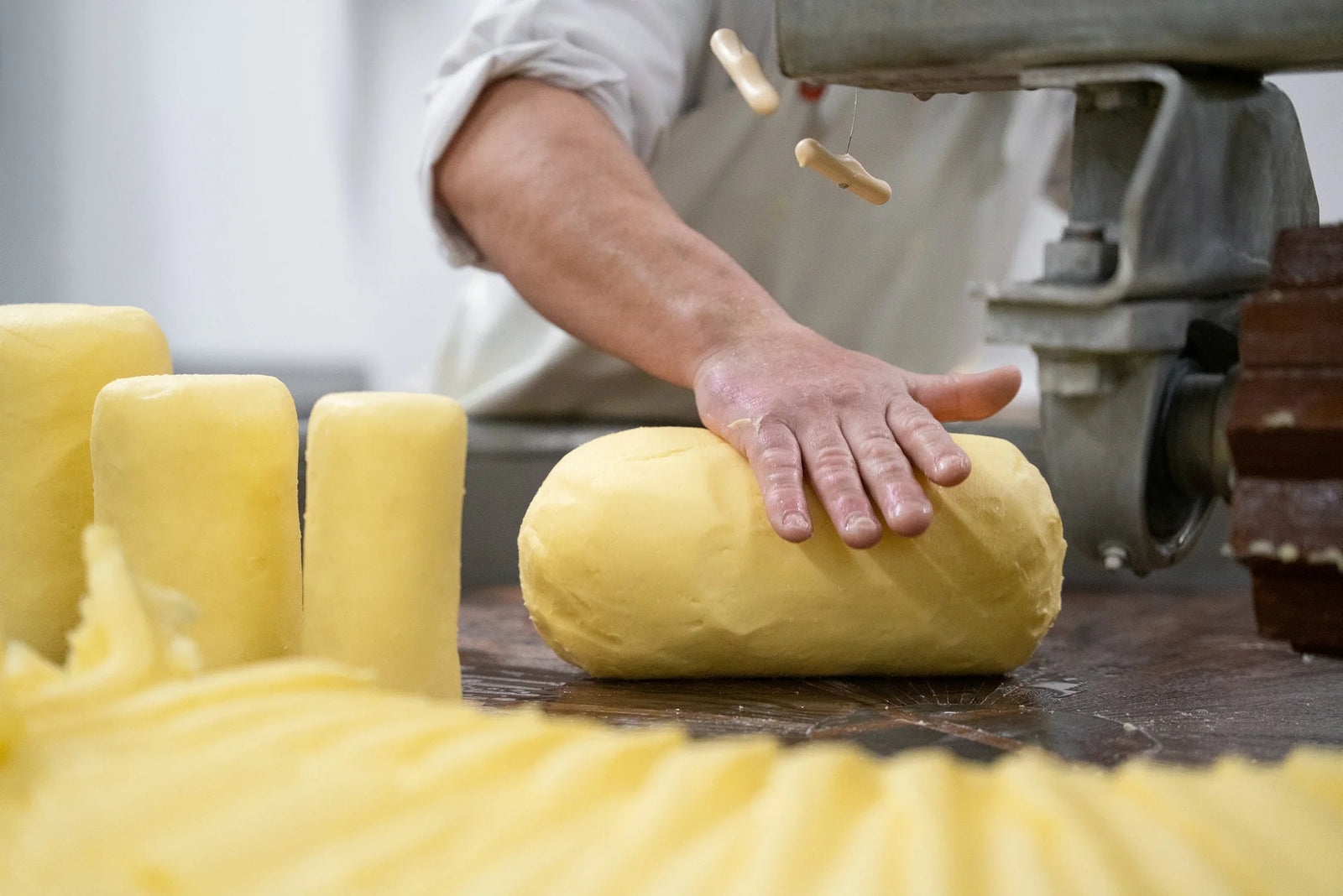 Artisan hand shaping premium French butter, small-batch, all-natural, grass-fed, clean-label
