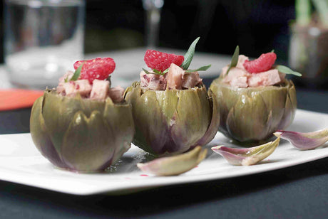 Purple artichokes stuffed with diced pig's trotter, dressed with a raspberry butter ravigote and fresh raspberries