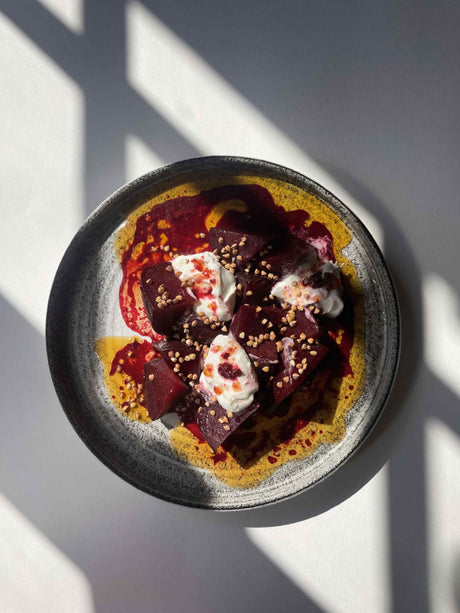 Diced beets in raspberry butter with torn burrata, toasted buckwheat seeds and fresh raspberries