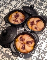 Baked cocotte of sliced boudin blanc arranged in a rosette over spiced butternut puree