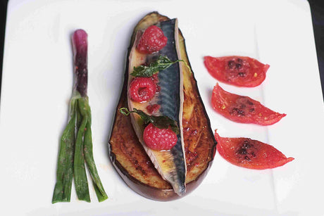 Grilled eggplant strips and mackerel fillet served bruschetta-style with raspberries and basil