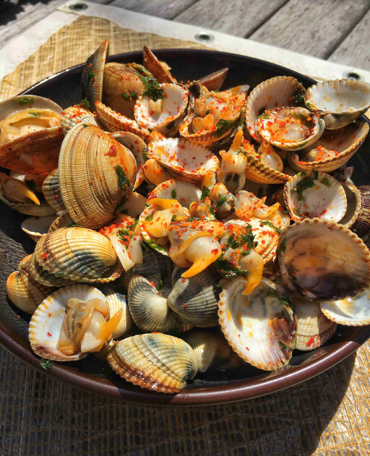 Cockles in a white wine and Espelette pepper butter sauce with chopped parsley