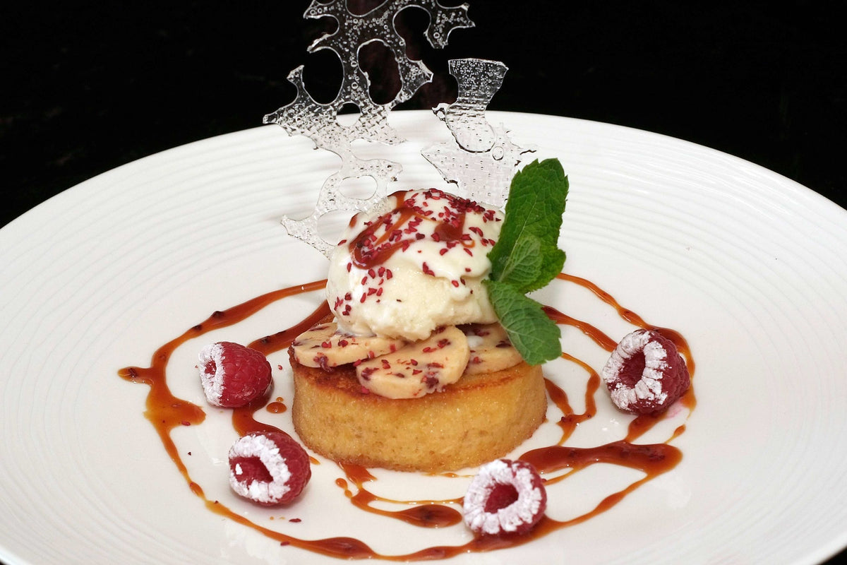 Brioche French toast with vanilla ice cream, fresh raspberries and Bordier raspberry butter caramel sauce