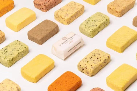Artisan French butter blocks in assorted flavors, including herb and spice varieties, premium quality and small-batch crafted.