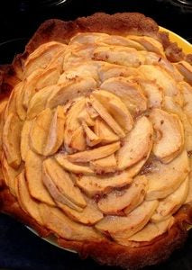Breton apple tart topped with sliced apples and dice of Bordier buckwheat butter