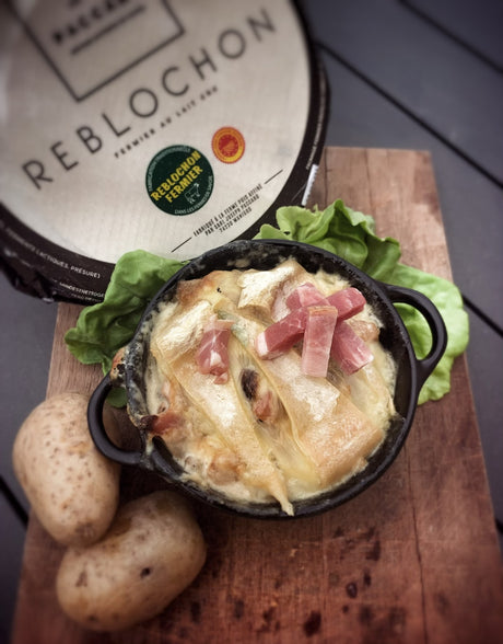 A baked tartiflette of potatoes, bacon and cream under a golden Reblochon rind