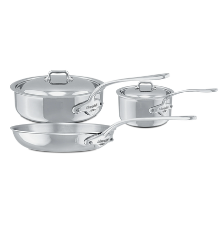 Mauviel stainless steel cookware set including a large pot with lid, a small saucepan, and a skillet.