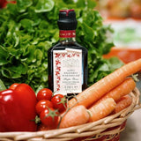 Balsamic vinegar bottle with vegetables in a basket