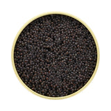 Top view of premium black caviar in a gold tin container.