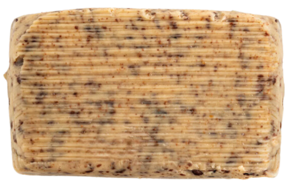 Rectangular bar of artisanal French butter with cocoa, ribbed texture, visible cocoa flecks