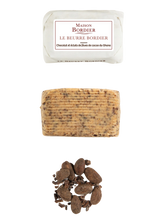 French butter with chocolate and cocoa nibs, unwrapped log, and whole cocoa beans