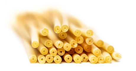 Close-up of dry artisan French pasta from The French Pantry, premium quality, on white background.