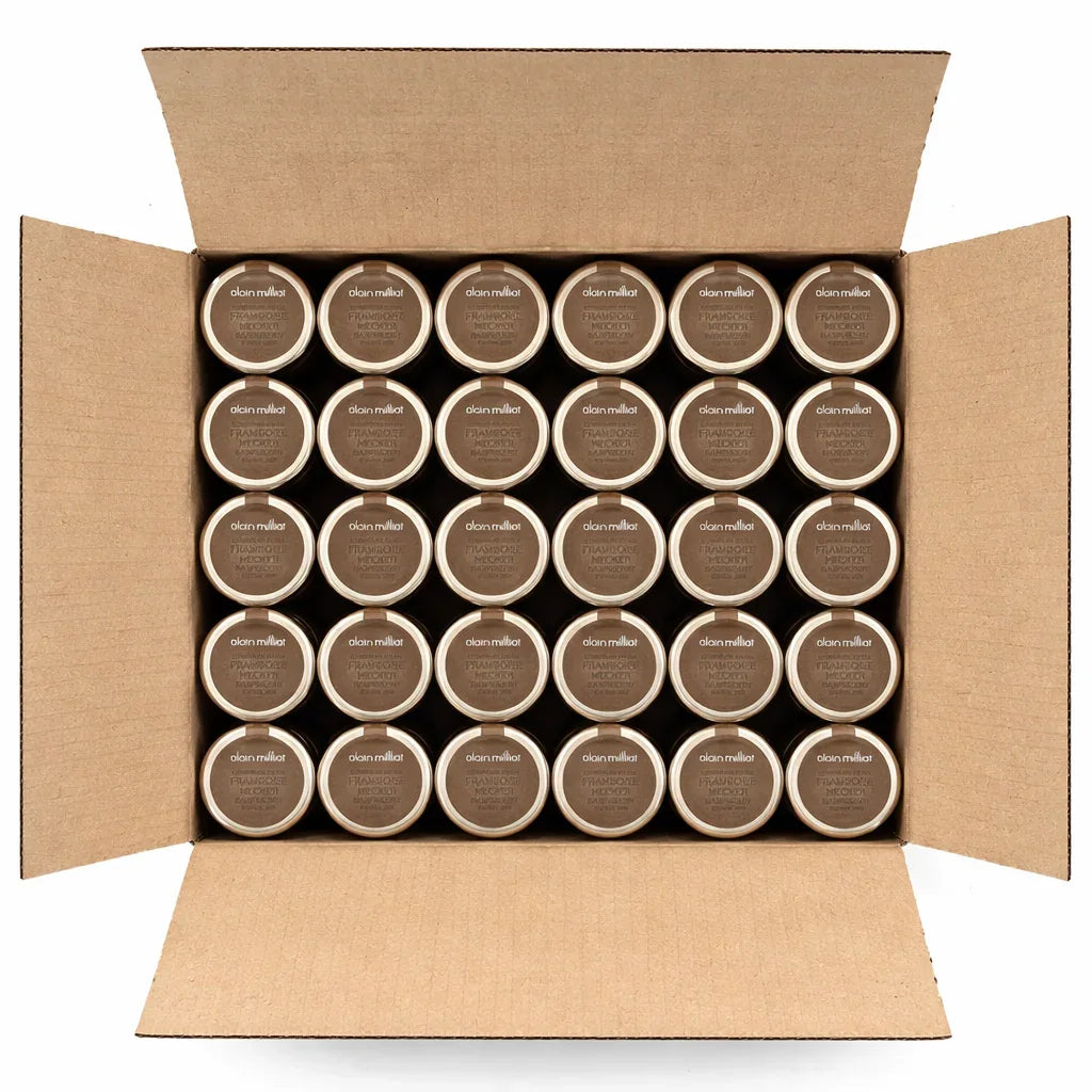 Open box filled with multiple jar lids labeled as Alain Milliat French Raspberry jam.