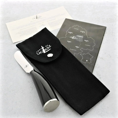 French black horn butter knife with pouch, certificate, and map on a light surface