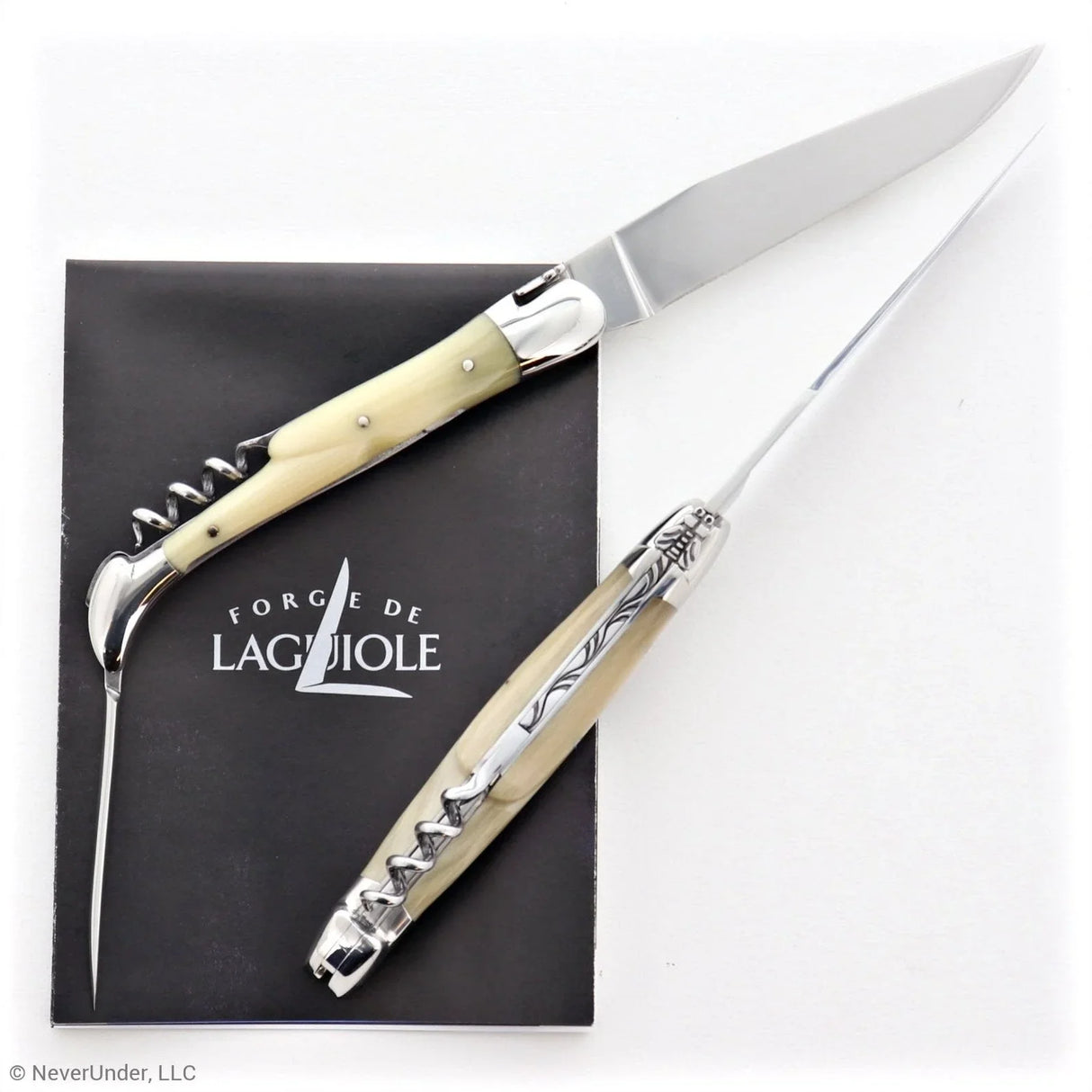 Traditional French folding knife with horn tip handle, awl, and corkscrew on white background.
