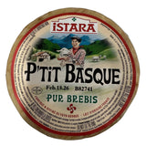 Round cheese with 'Pétit Basque' label on a white background