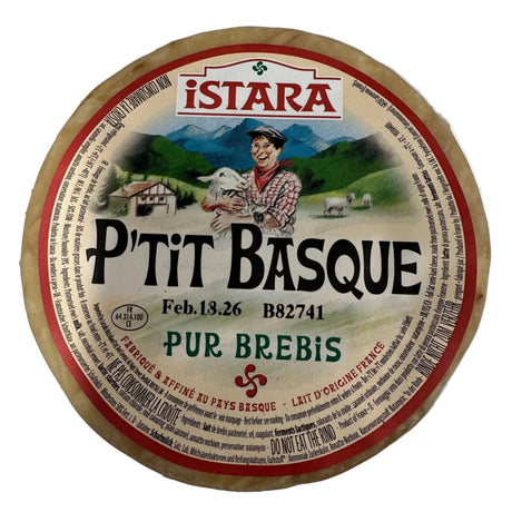 Round cheese with 'Pétit Basque' label on a white background