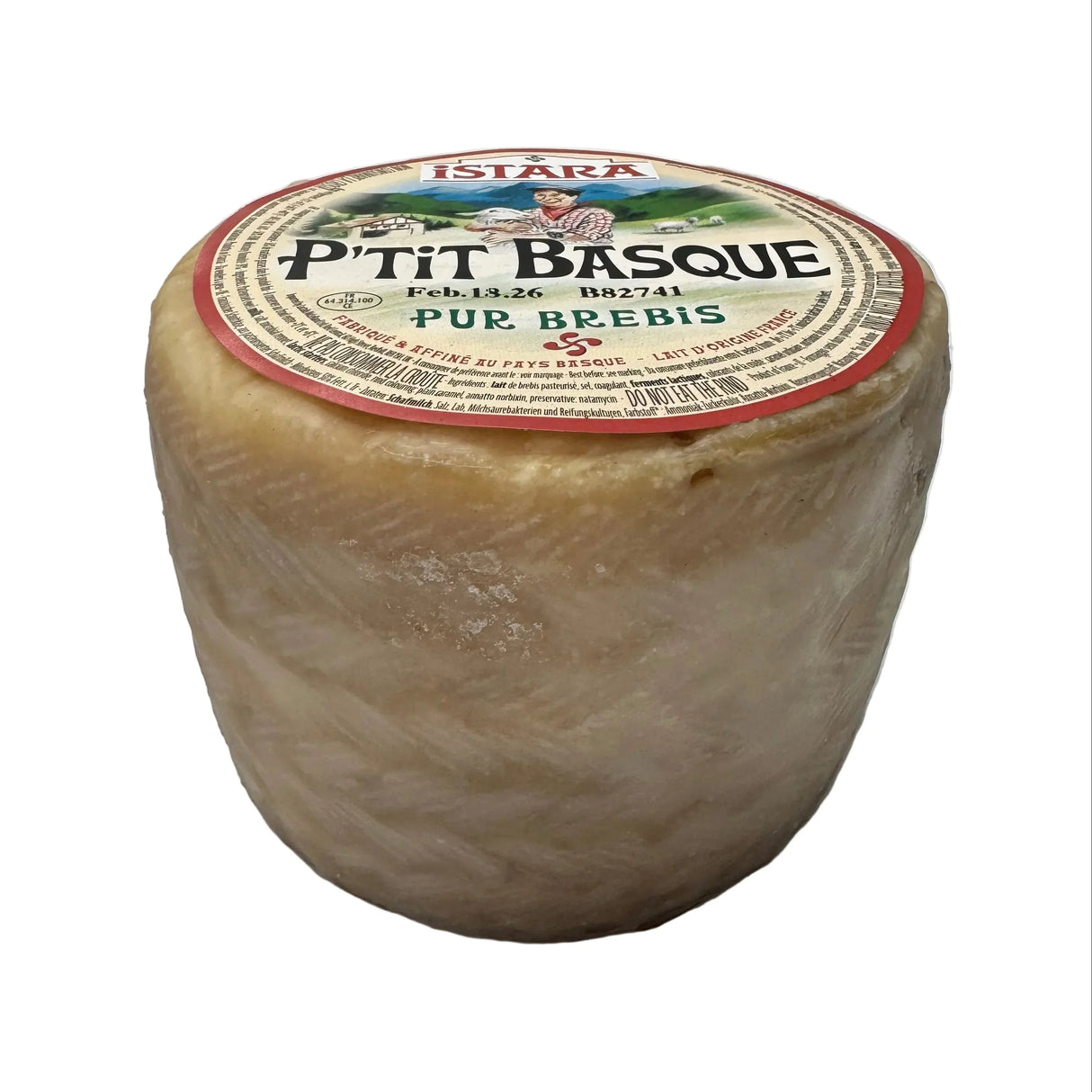 Round French P'tit Basque sheep's milk cheese with rustic rind and detailed label