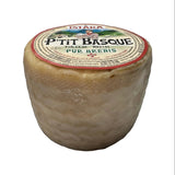 Round French P'tit Basque sheep's milk cheese with rustic rind and detailed label