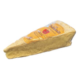 Wedge of Le Chatelain Brie soft ripened cheese in clear plastic packaging.