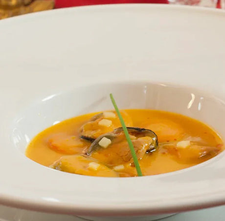 French mussels in creamy sauce garnished with chive, artisan gourmet dish from The French Pantry