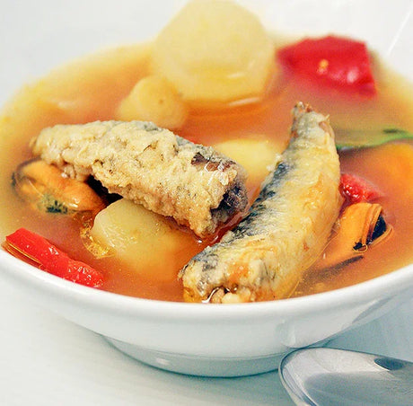 Bowl of artisan seafood soup with sardines, potatoes, and vegetables from The French Pantry