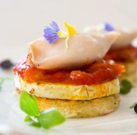 Gourmet French appetizer with squid, zucchini, tomato sauce, edible flowers, French Pantry