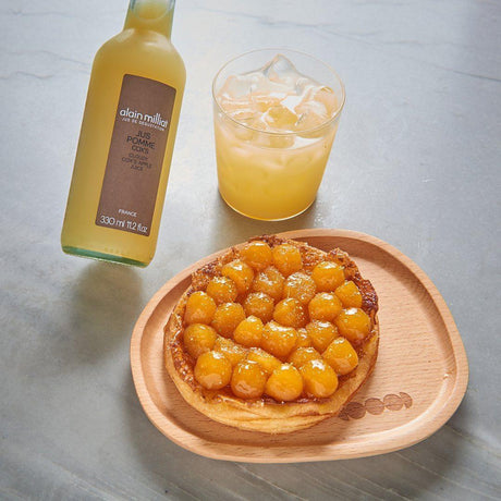 French apple tart and cloudy apple juice on wooden plate, artisanal French pantry gourmet food
