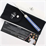 Forge de Laguiole Le Nomade cheese knife with blue handle, black pouch, and authenticity certificate.