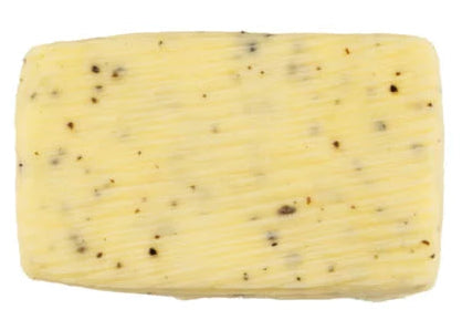 French truffle butter block with visible truffle specks on a white background